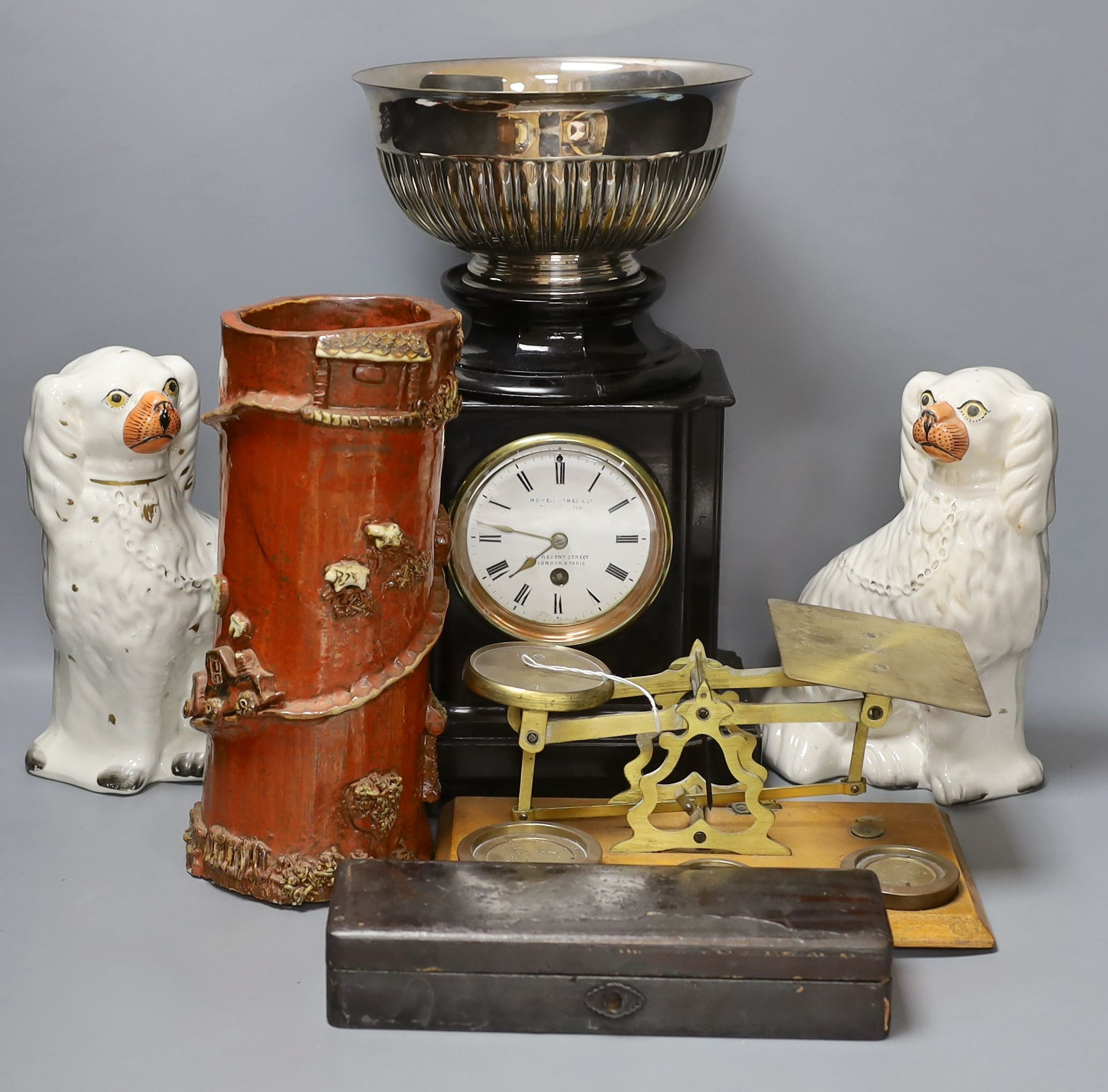 A pair of Staffordshire dogs, together with a pottery brush pot, Howell James mantle clock and other miscellaneous items including postal scales (7)